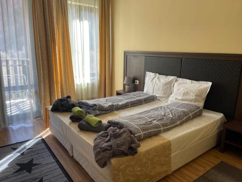 um quarto com 2 camas e toalhas em Мия 2 Спа хотел Свети Спас em Velingrad