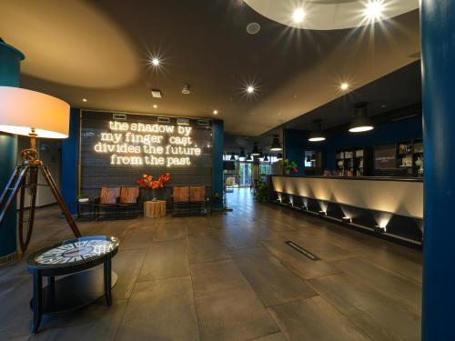 a restaurant with a sign in the middle of a lobby at La Meridiana Bleisure Hotel in Perugia