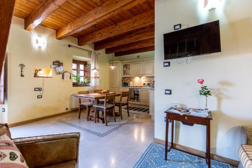 a kitchen and living room with a table and chairs at Affittacamere Is Coronas in Ìsili
