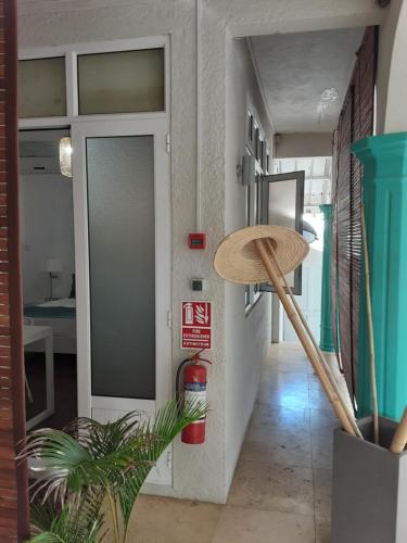 a hallway with a door and a hat on the wall at Explora Prestige in Blue Bay