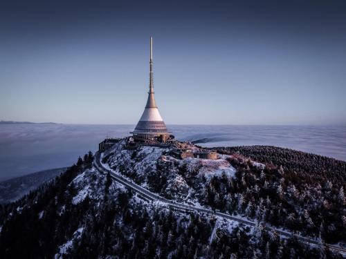 an image of a tower on top of a mountain at Ještěd golf restaurace a penzion in Světlá pod Ještědem