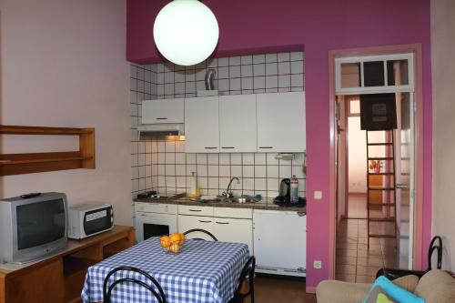eine Küche mit einem Tisch und einem Tischtuch darauf in der Unterkunft Hospedaria Verdemar in Horta