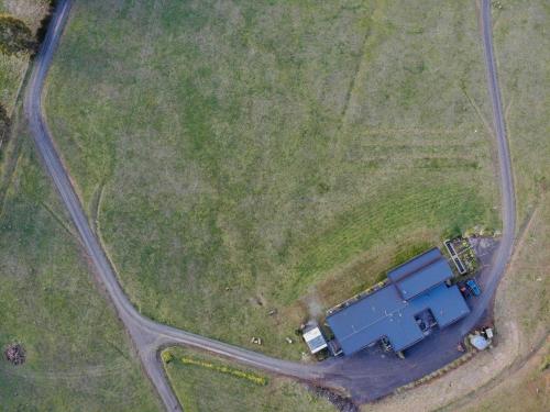 an overhead view of a field with a blue container at Hanging Rock Views in Woodend