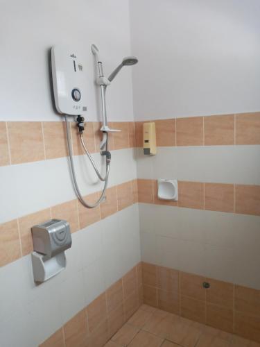 a shower in a bathroom with a shower head at Twin Luck Home Stay in Ipoh