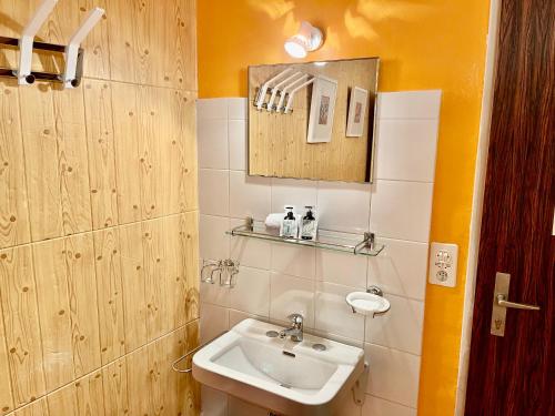 a bathroom with a sink and a mirror at Weisses Rössli in Leukerbad