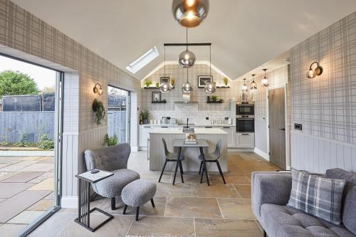 a kitchen and living room with a table and chairs at Host & Stay - The Stables in Yarm