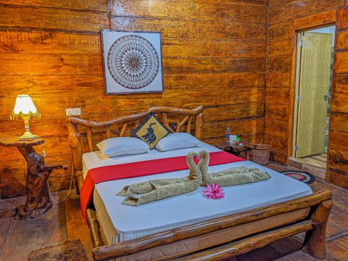 a bedroom with a bed with stuffed animals on it at Sigiri Choona Lodge 'unique sunrise viewpoint' in Sigiriya