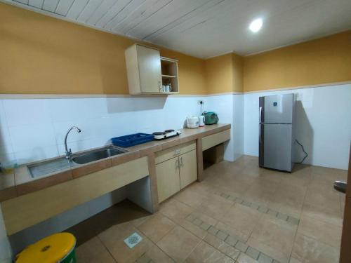 a kitchen with a sink and a refrigerator at Pavilion Fahrenheit 88 Bukit Bintang 3 bedrooms in Kuala Lumpur