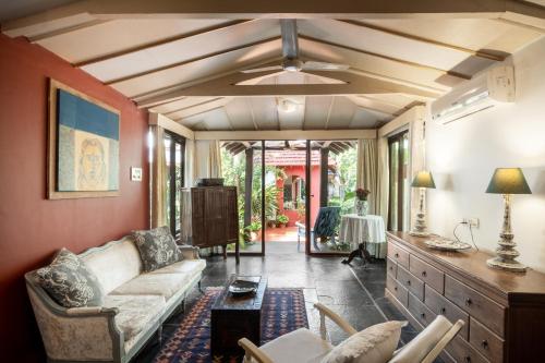 a living room with a couch and a table at Casa Britona in Panaji