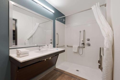 a bathroom with a sink and a shower at WoodSpring Suites Phoenix-Deer Valley in Phoenix