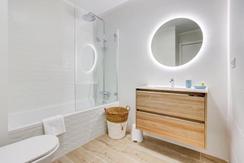 a white bathroom with a sink and a mirror at The butterflies of Sueno Azul in Callao Salvaje