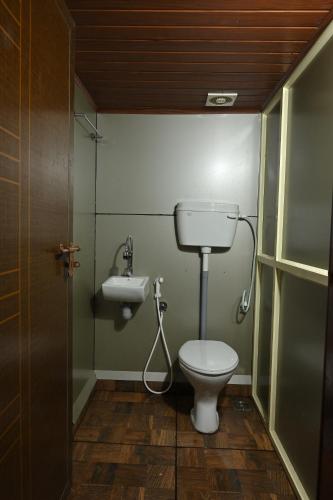 a bathroom with a toilet and a sink at Anandavana Jungle Living By LexStays - Kanthalloor-Marayur in Kanthalloor