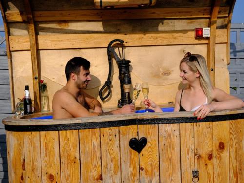 a man and a woman in a hot tub at SECRET WELLNESS in Bodonci