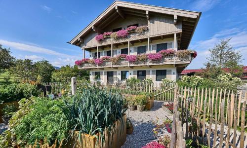 a house with flower boxes on the side of it at Hof Hauserbichl in Fischbachau