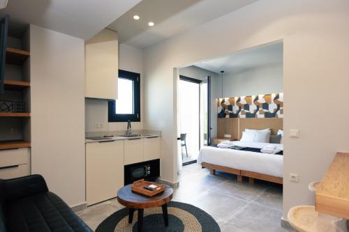 a bedroom with a bed and a living room at Chapter 02 Gallery Suites - ex GD Gallery Suites in Heraklio Town