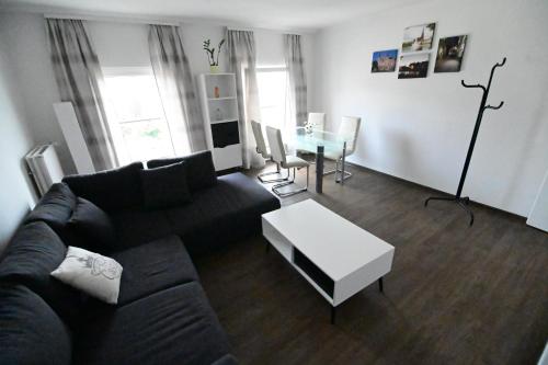 a living room with a couch and a table at Pension am Schloss in Schwerin