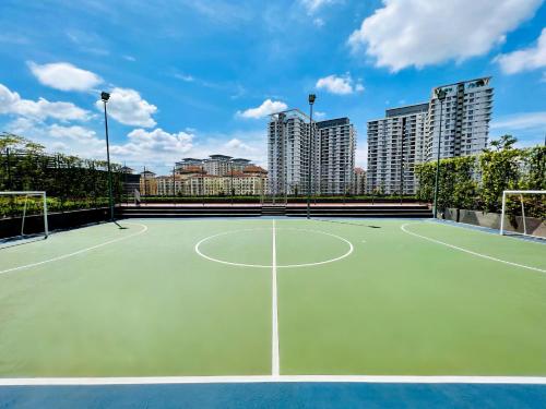 a tennis court with tall buildings in the background at KL COSY CONDO - NEW Stylish home above KL East Mall in Kuala Lumpur