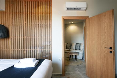 a hotel room with a bed and a couch at Chapter 02 Gallery Suites - ex GD Gallery Suites in Heraklio Town