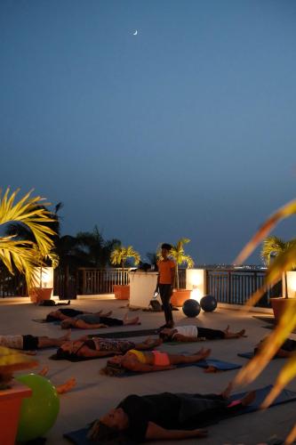 a group of people doing yoga on the beach at Hotel Odjo d'água in Santa Maria