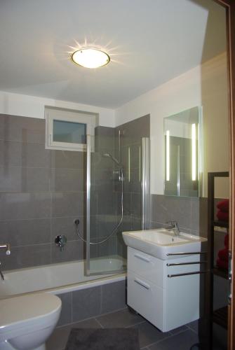 a bathroom with a shower and a sink and a toilet at Appartement Klausner in Kitzbühel