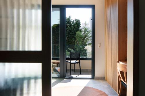 a glass door leading to a patio with a table at Chapter 02 Gallery Suites - ex GD Gallery Suites in Heraklio Town