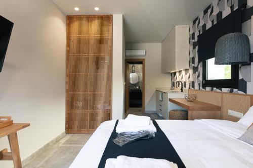 a bedroom with two beds and a kitchen at Chapter 02 Gallery Suites - ex GD Gallery Suites in Heraklio Town