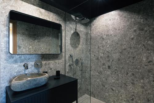 a bathroom with a sink and a mirror at Chapter 02 Gallery Suites - ex GD Gallery Suites in Heraklio Town