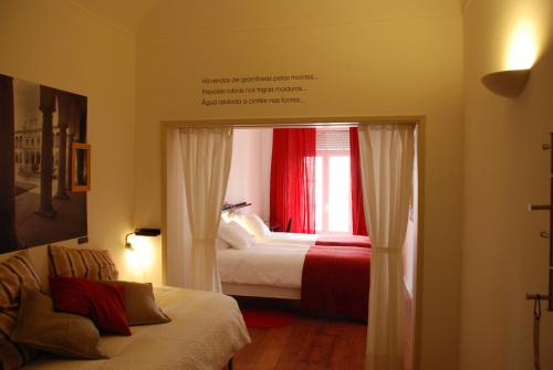 a bedroom with a bed and a window at StayInn City - Évora in Évora