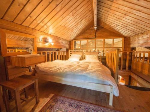 a bedroom with a large bed in a wooden room at Charming chalet in Durbuy near adventure valley in Durbuy