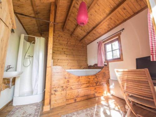 a bathroom with a sink and a tub in a room at Charming chalet in Durbuy near adventure valley in Durbuy
