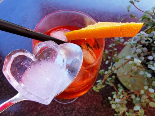 a heart shaped drink in a glass with a spoon at Hotel Schmidt am Markt in Meppen