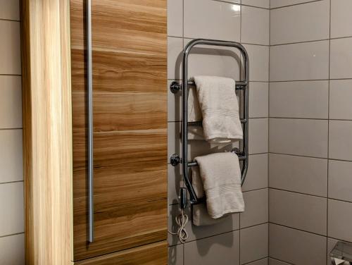 a towel rack in a bathroom with towels at Hotell Bro in Kristinehamn