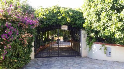 an entrance to a garden with an iron gate at Casa Rosalba in San Vito lo Capo