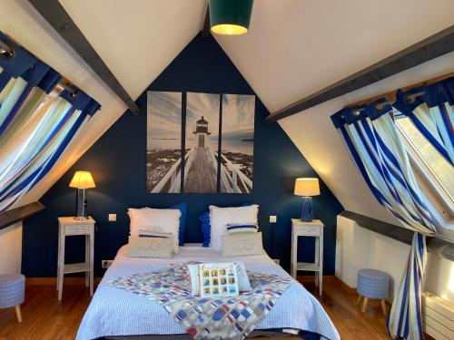 a blue bedroom with a bed and two night stands at Ar Couette in Le Bono