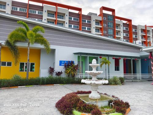 a fountain in a courtyard in front of a building at Pavilionvillie M1T570 by irainbow in Ipoh