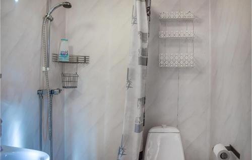 a white bathroom with a shower and a toilet at Awesome Home In Kyrkhult With House A Panoramic View in Kyrkhult