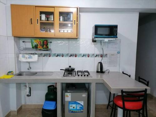 a small kitchen with a sink and a counter top at B1-Departamento Bolognesi in Chiclayo