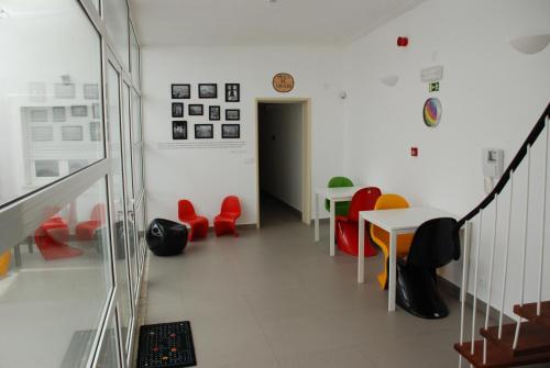 a hallway with tables and chairs and a clock on the wall at StayInn City - Évora in Évora