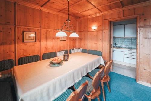 a dining room with a long table and chairs at Hotel Garni Almjur in Sankt Anton am Arlberg