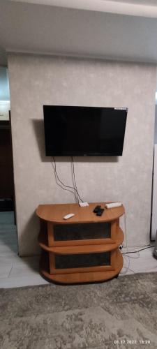 a flat screen tv sitting on top of a table at Бухар жырау 45 in Karagandy