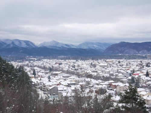 a view of a city with snow covered buildings at Altavista mountain apartment in Samokov