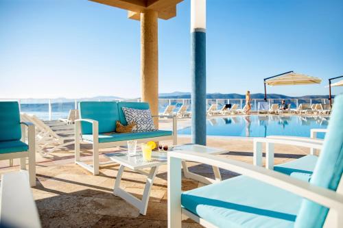 a patio with chairs and a swimming pool at TUI BLUE Makarska - Adults Only in Igrane