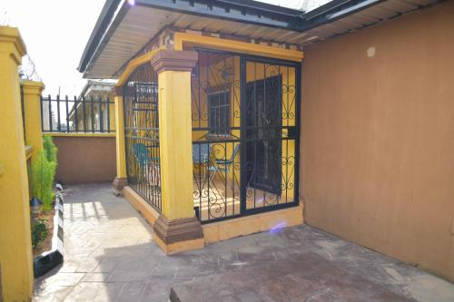 an iron gate on the side of a building at Living Green APARTMENTS AIRPORT PICK UP in Benin City