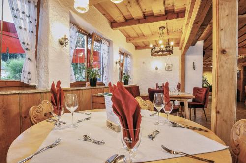 a dining room with a table with wine glasses at Landhotel Berger in Ainring