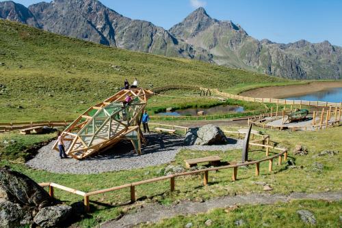 a group of people standing on a wooden bridge in a mountain at Gaestehaus Berger in Sankt Jakob in Defereggen