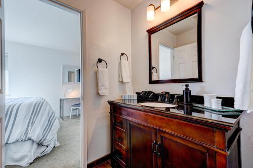 een badkamer met een wastafel en een spiegel bij with Pool & Hot Tub, Beautifully Appointed 4BR Home! home in Windsor