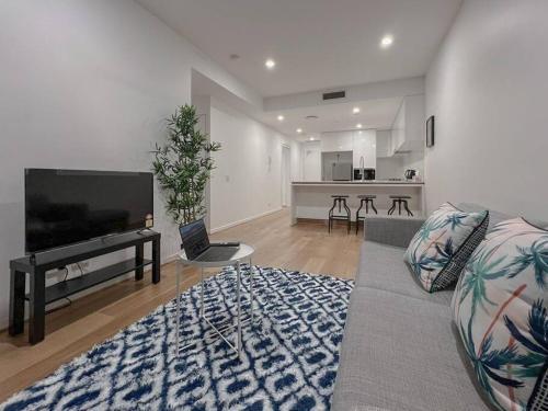 a living room with a flat screen tv and a couch at 1.5BR apartment Fortitude Valley in Brisbane