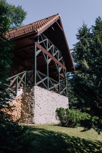 a building with a roof on top of a stone wall at Brenna Leśnica in Brenna