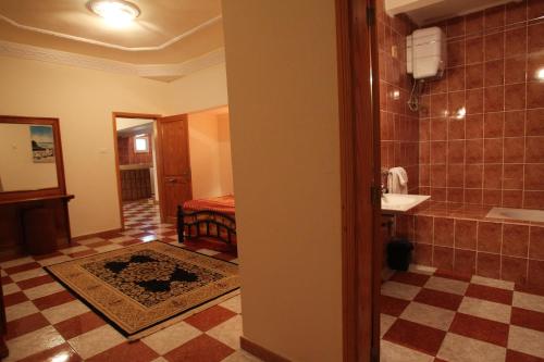 a bathroom with a shower and a sink and a toilet at Hotel Emira in Nouakchott