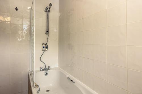 a bathroom with a shower and a bath tub at Bower House Inn in Eskdale